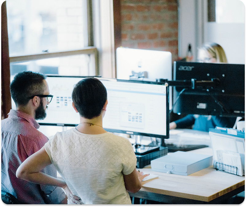 built mighty coworkers at a desk looking at a monitor for custom wordpress development services